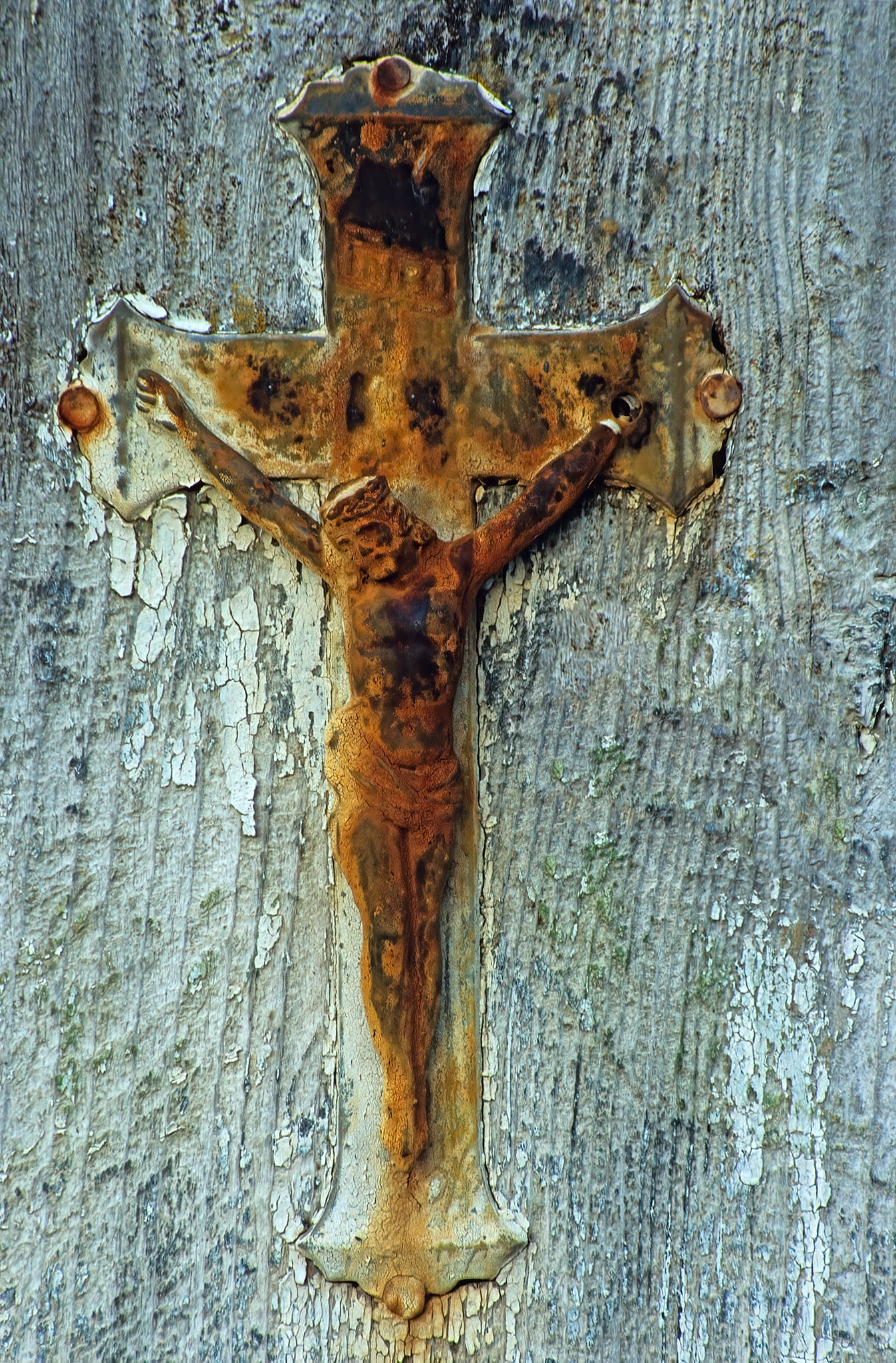 Rusted Christ on Indigenous grave marker, Thompson River Canyon, near Skihist, British Columbia, Canada.